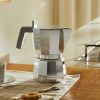 A coffee maker with a familiar and at the same time innovative form. Designed by architect David Chipperfield, Moka is an artist's interpretation of a timeless icon of the Italian culture. Chipperfield introduces a series of details that make the Moka design new and even more functional, such as the flat lid on which to place the cups to be heated - allowing optimum enjoyment of the aroma and flavour of the drink. For those who don't want to compromise on the unmistakeable taste of coffee prepared with an espresso coffee maker.